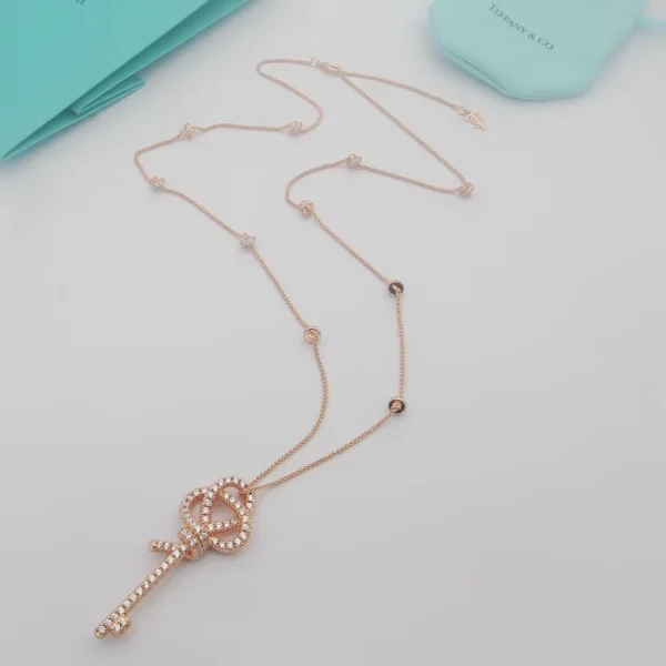 Close-up of Tiffany Knot Key Pendant in rose gold, detailed with brilliant-cut diamonds and sculptural curves