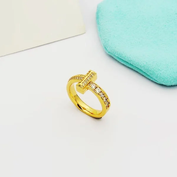 Close-up of Tiffany T T1 Narrow Ring showcasing sparkling diamonds set in polished yellow gold band